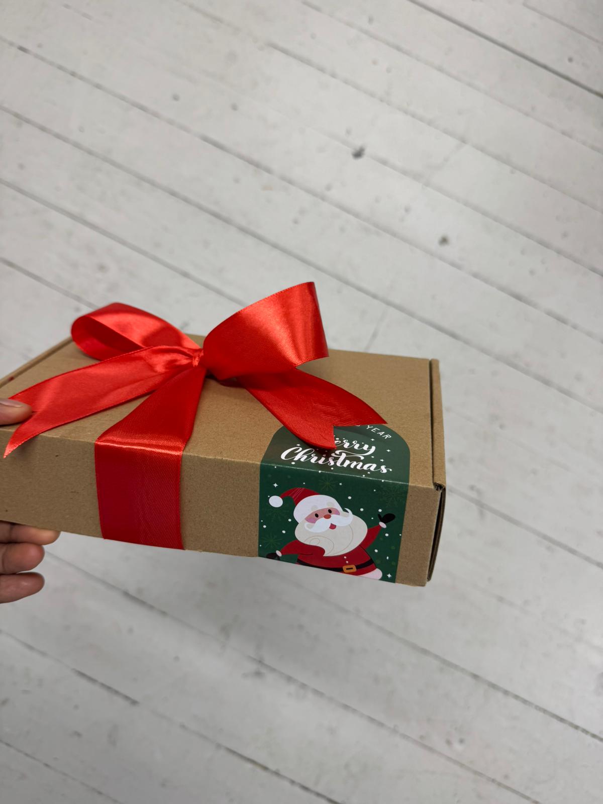 Festive gift box for men featuring wallet, Christmas socks, and sweet treat