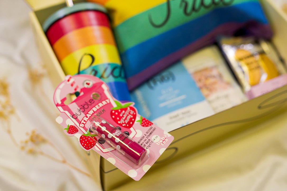 Pride gift hamper for her with colorful purse, lip gloss, and soothing self-care items