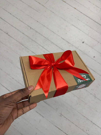 Christmas gift set for him including men’s wallet, cosy socks, and festive snack