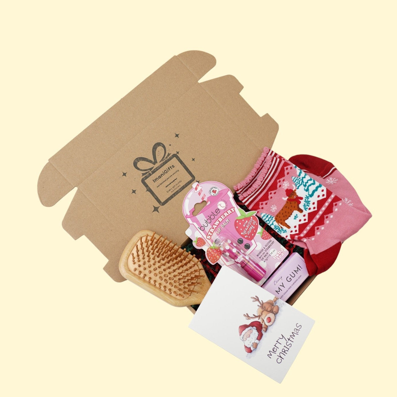 Festive Christmas gift box with red ribbon and holiday decorations on a wooden table